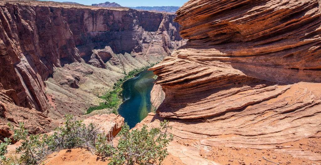 rock layers of navajo sandstone in front of the colorado river at horseshoe bend