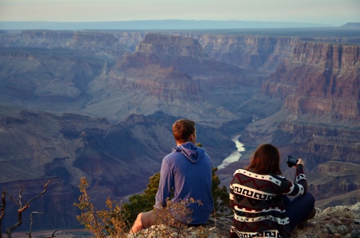 11two people gazing out at a dusky grand canyon