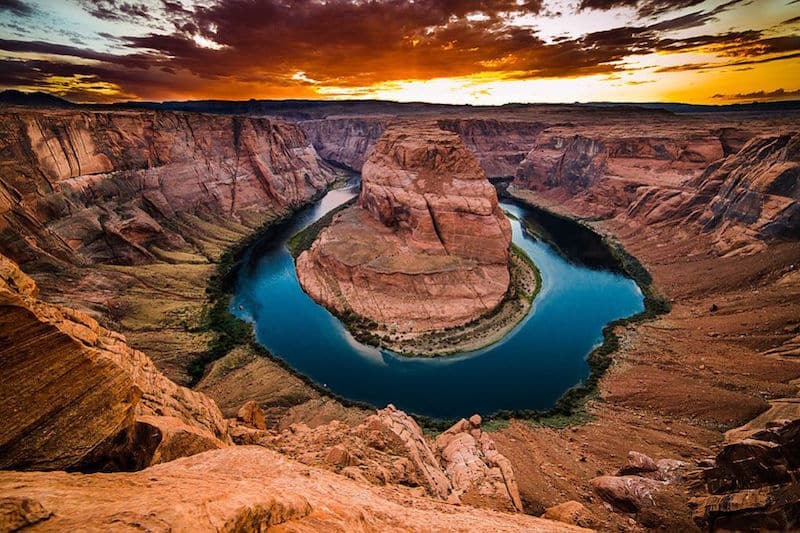 horseshoe bend glowing blue at sunset