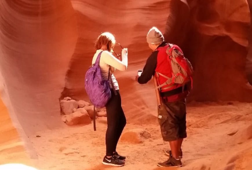 two people standing inside antelope canyon