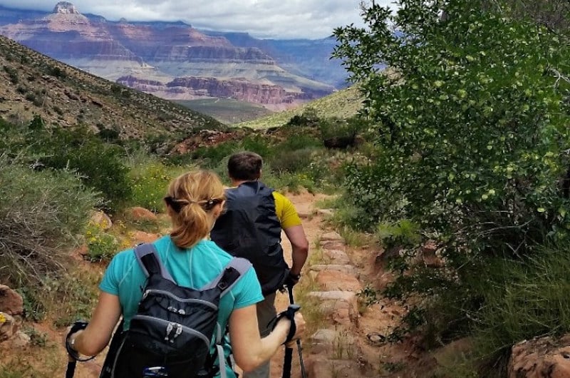 two hikers on a trail in grand canyon