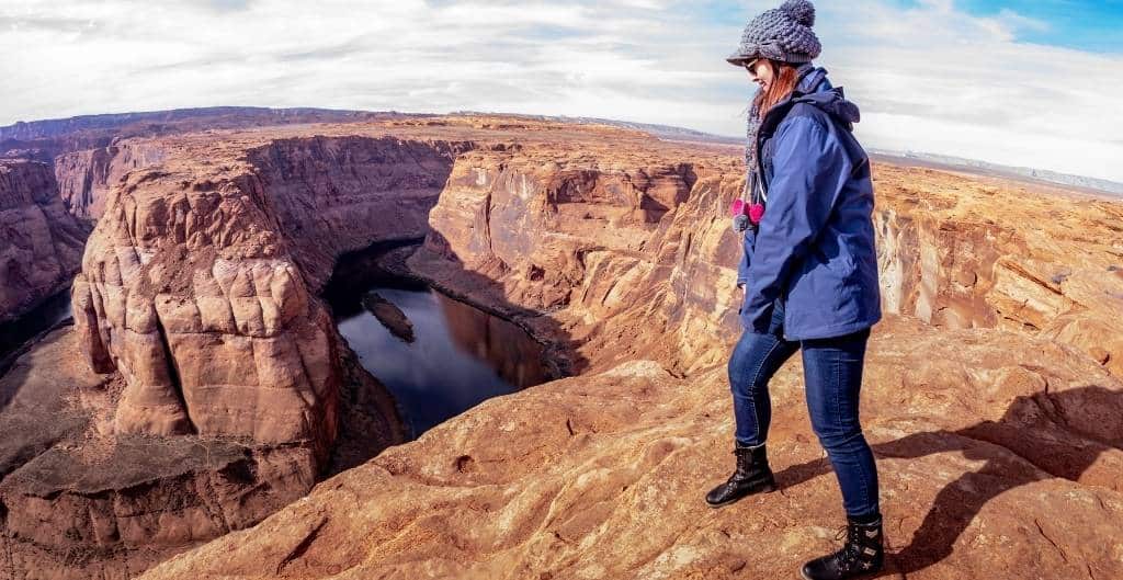 woman standing at the edge of horseshoe bend
