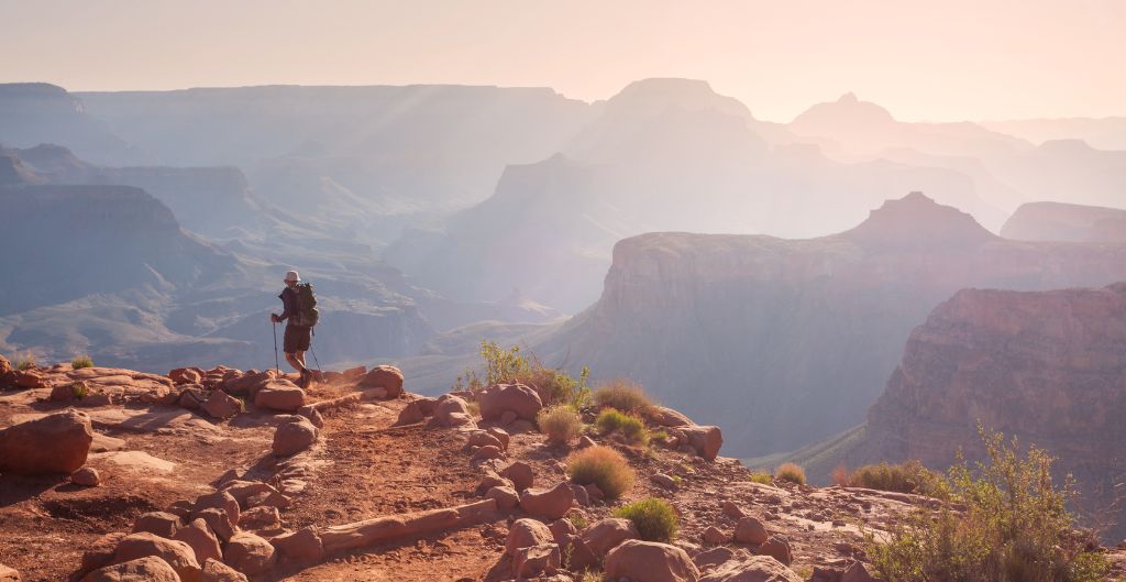 person hiking in the grand canyon in soft light