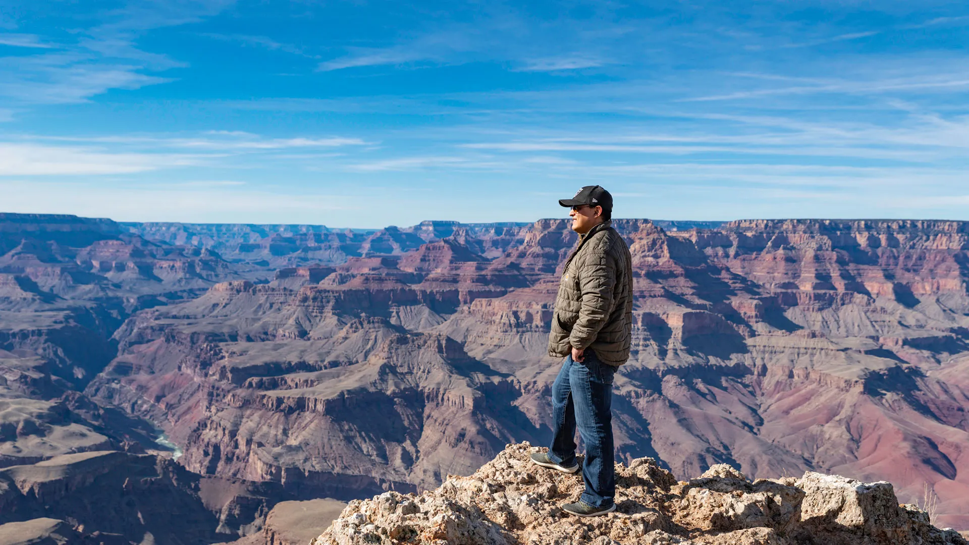 man looking out over the grand canyon