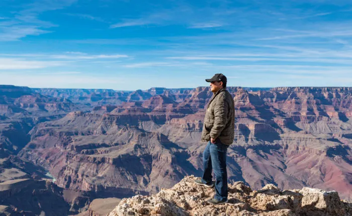 man looking out over the grand canyon