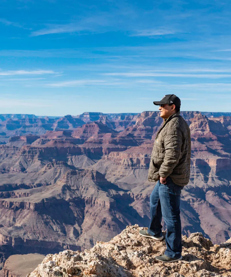 man looking out over the grand canyon