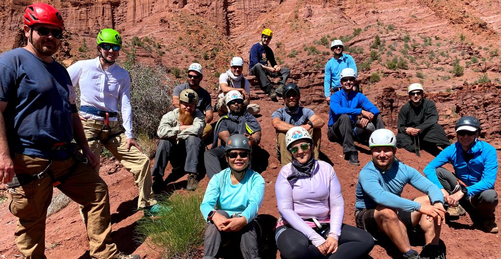 11group of coworkers wearing climbing helmets on a team-building retreat