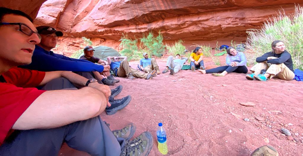 team sitting in a circle in a canyon at a corporate workshop