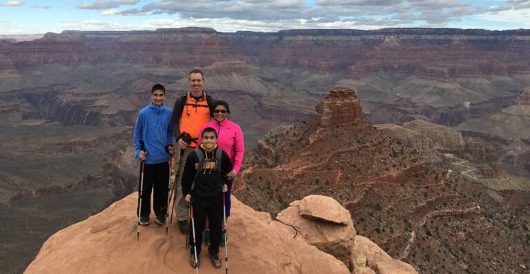 11parents and two kids posing for a photo at the grand canyon