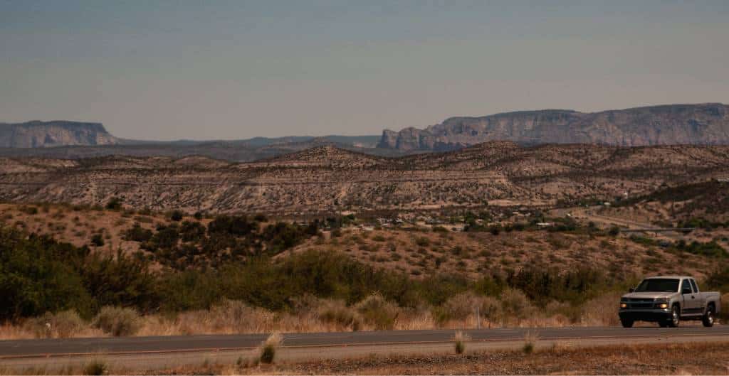 pickup truck driving on a road from phoenix to the grand canyon