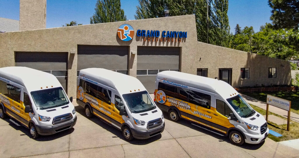 3 grand canyon adventures luxury transportation vans in front of the GCA headquarters
