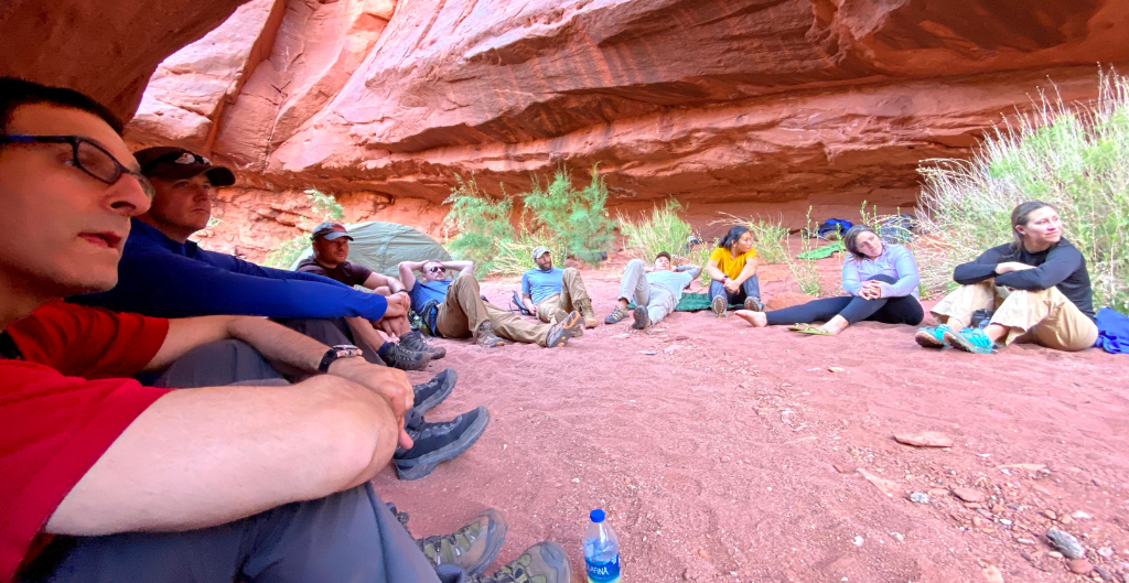 corporate group sitting in a circle team building while on a grand canyon retreat 