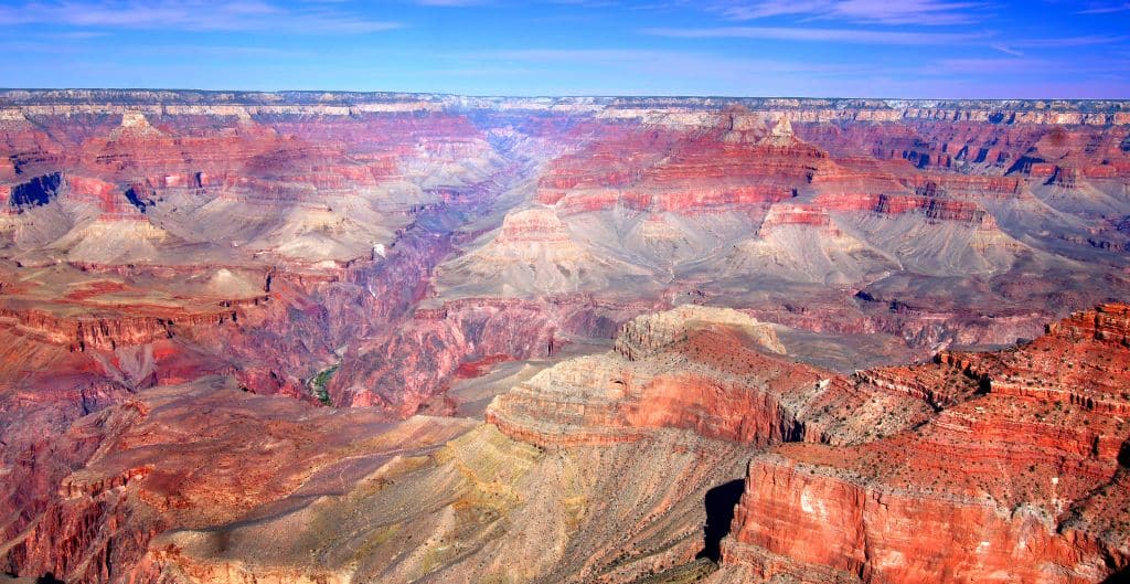 brilliant red rock of the grand canyon in front of a bright blue sky