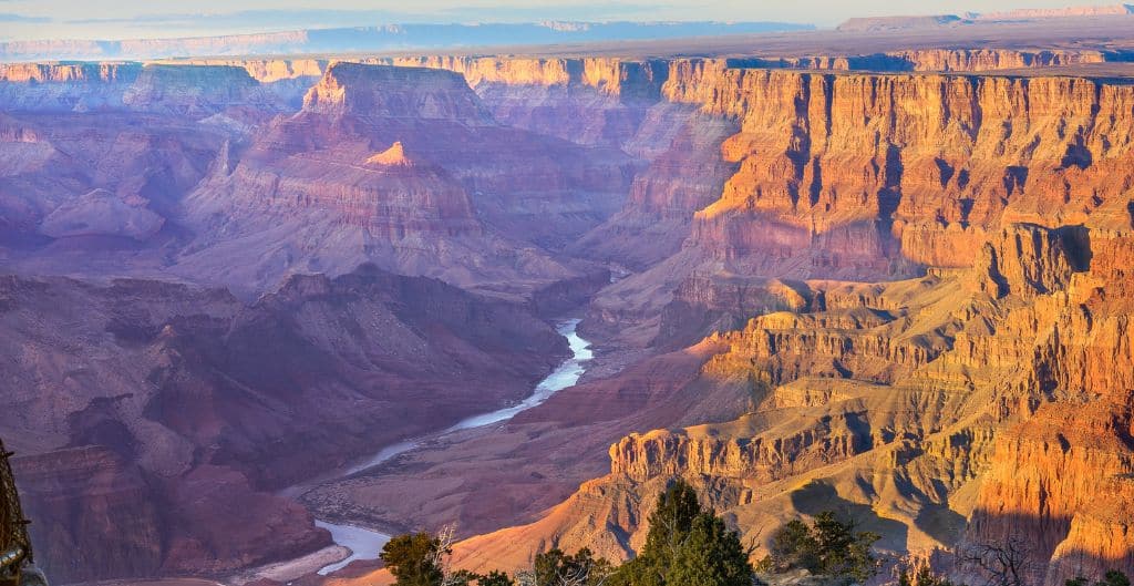 The river flows through the scenic grand canyon
