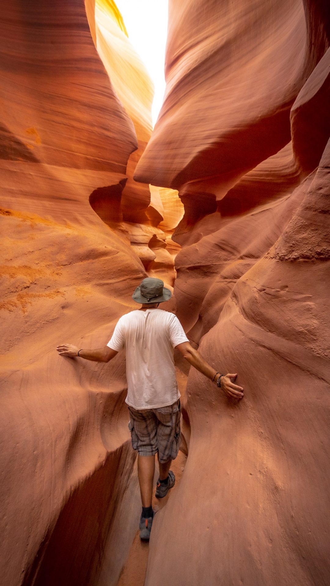 person hiking through a slot canyon in Northern Arizona